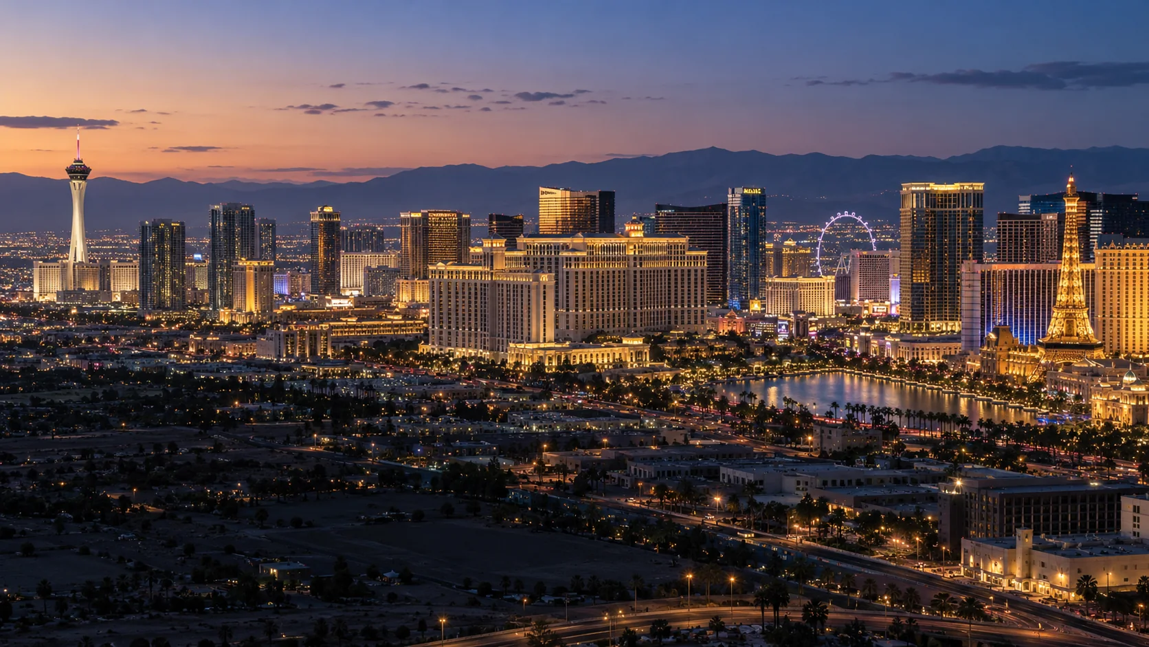 Las Vegas skyline at dusk with illuminated towers and desert mountains